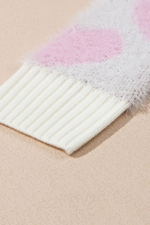 Fuzzy heart jacquard knit sweater in blush pink with ribbed cuffs and hem.