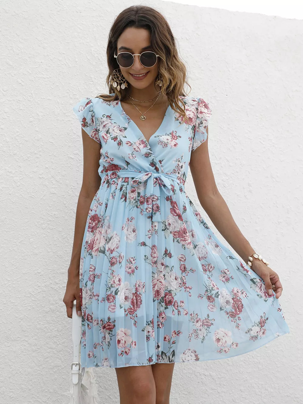Light blue floral pleated dress with ruffle sleeves and a belted waist.