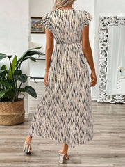 Floral print midi dress in black and apricot with cap sleeves and a-line cut.
