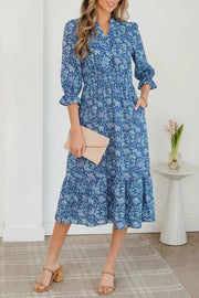 Blue floral cotton midi dress with cinched waist and frilled cuffs