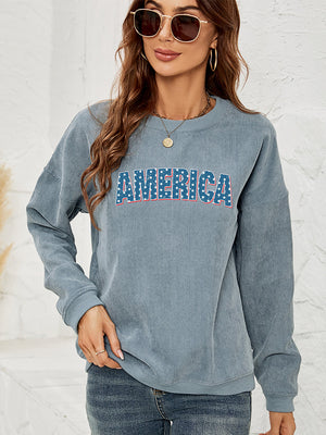 French Blue corduroy sweatshirt with "AMERICA" graphic, crewneck, long sleeves.