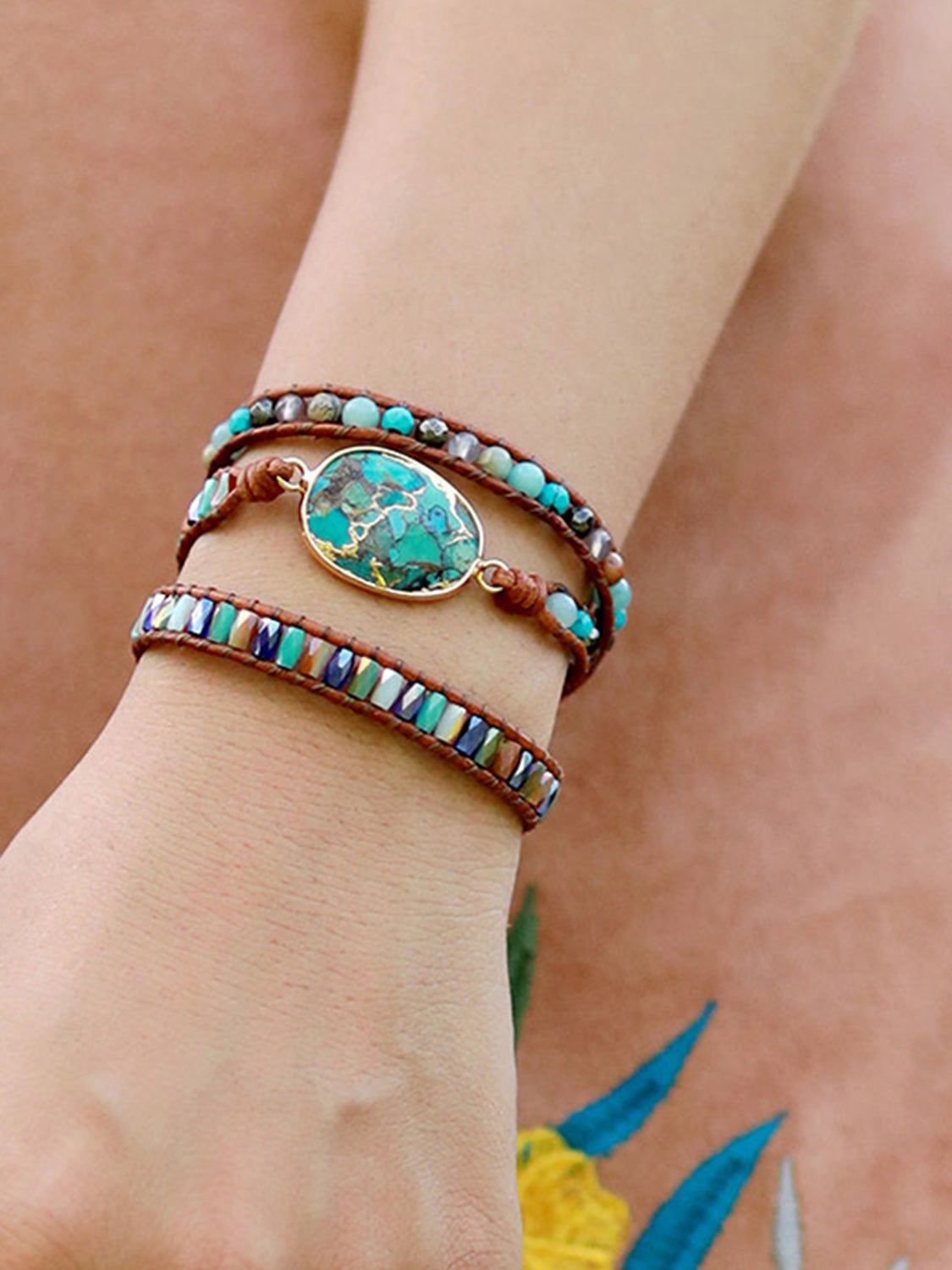 Aqua stone and leather wrap bracelet with beaded accents and oval center stone.