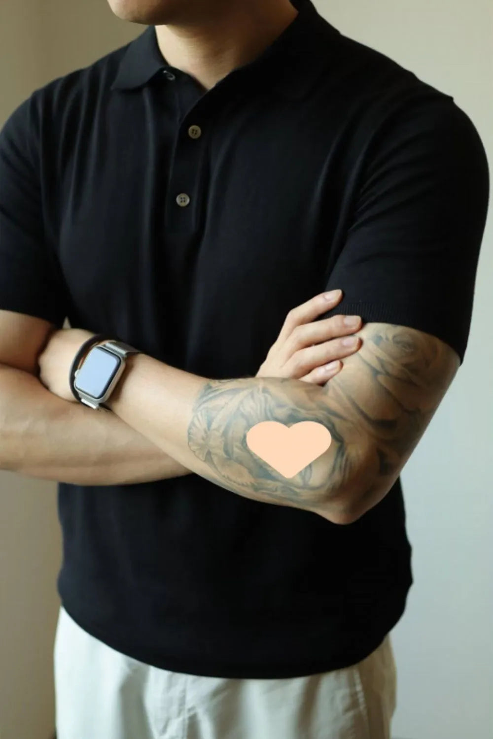Black fine-gauge knit polo shirt with refined placket and short sleeves.