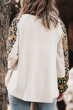 White waffle knit top with leopard print sleeves and cuffs