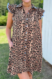 Leopard print cotton mini dress with lace trim, button front, and ruffled sleeves.