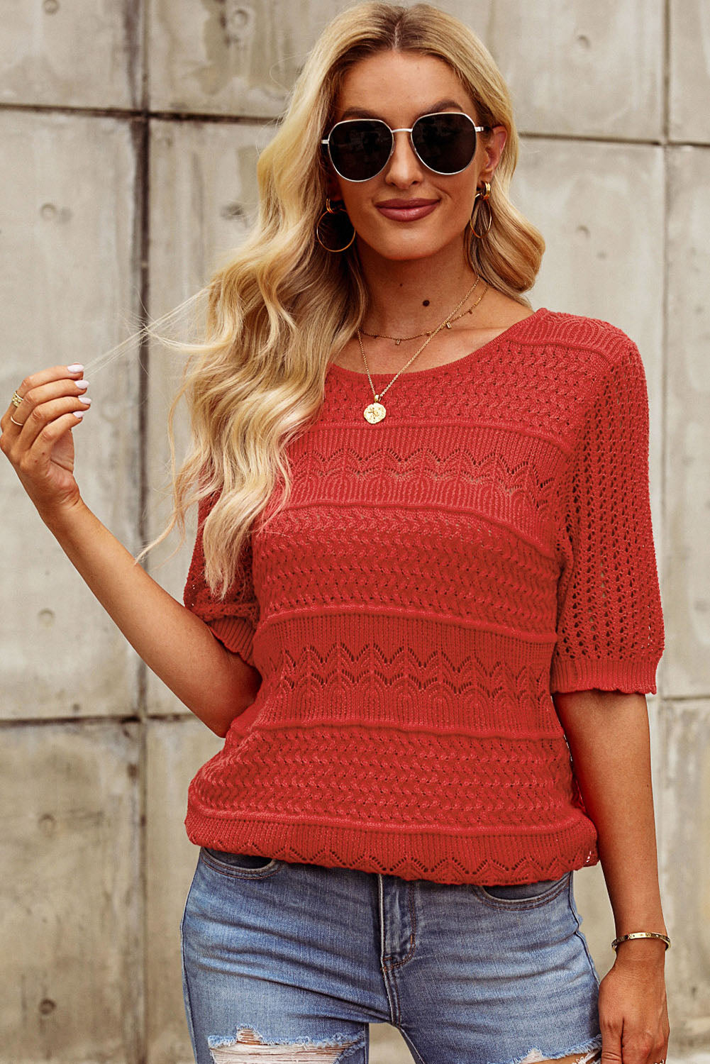 Rust openwork knit tee with short sleeves and a crew neck.