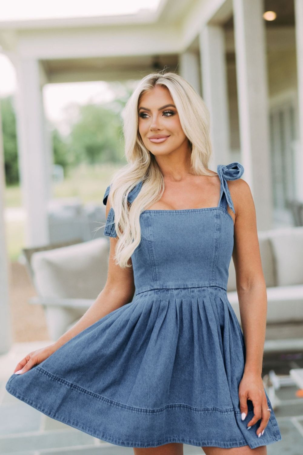 Denim fit-and-flare mini dress with tie straps and square neckline in dusty blue.