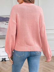 Pink acrylic knit cardigan with embroidered blossom detail on sleeve