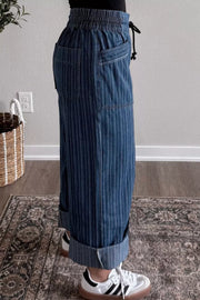 Dark striped maternity jeans with drawstring waist and cuffed wide legs.