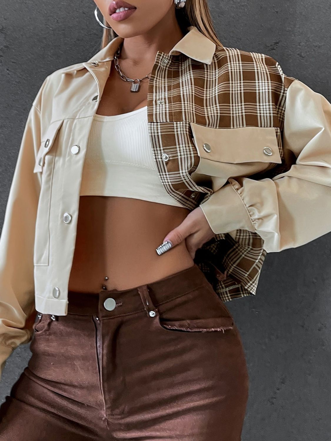 Beige panelled plaid and faux leather jacket with buttoned pockets and collar.