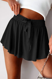 Black flared skort with elasticated waist and tie detail