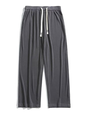 Men's dark gray ribbed drawstring wide leg sweatpants with pockets.