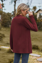 Burgundy textured knit cardigan with long sleeves and a mock neck, shown from the back.