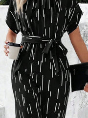 Black wide-leg jumpsuit with raindrop print, short sleeves, and a tie waist.