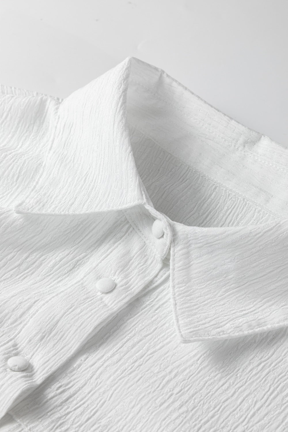 White crinkled texture button-down shirt with classic collar and button detail