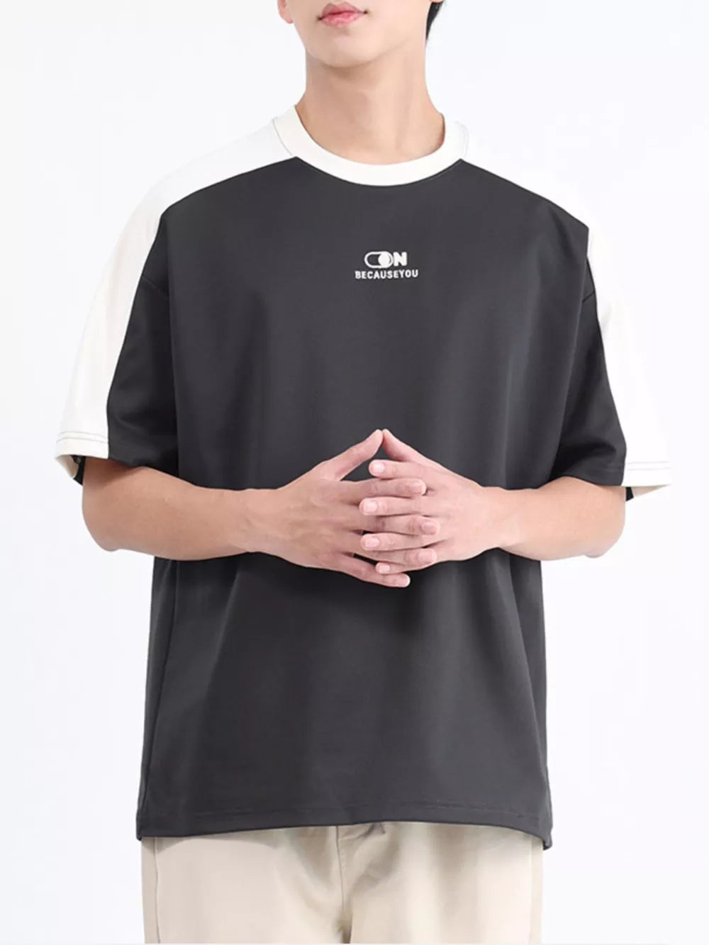 Men's contrast stitch t-shirt in dark gray with white sleeves and logo detail.