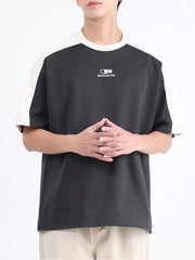 Men's contrast stitch t-shirt in dark gray with white sleeves and logo detail.