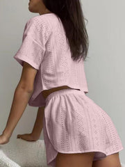 Dusty pink perforated crop top and shorts set with short sleeves and elastic waist.