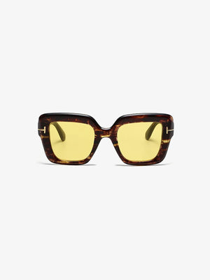 Geometric acetate sunglasses with yellow lenses and tortoise shell frames.