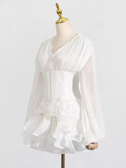 White ruffle mini dress with balloon sleeves, ruched bodice, and floral detail