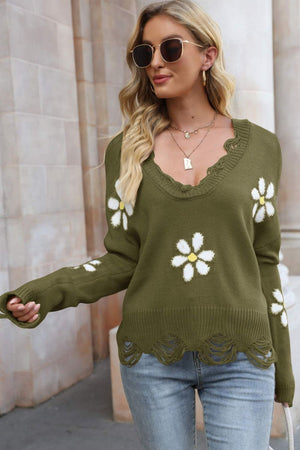 Green acrylic sweater with daisy appliques, distressed neckline and hem.