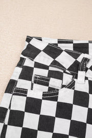 Checkerboard distressed cropped jeans in black and white denim with visible stitching details.