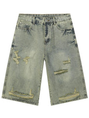 Distressed culotte denim shorts in medium wash with ripped details and a wide leg.