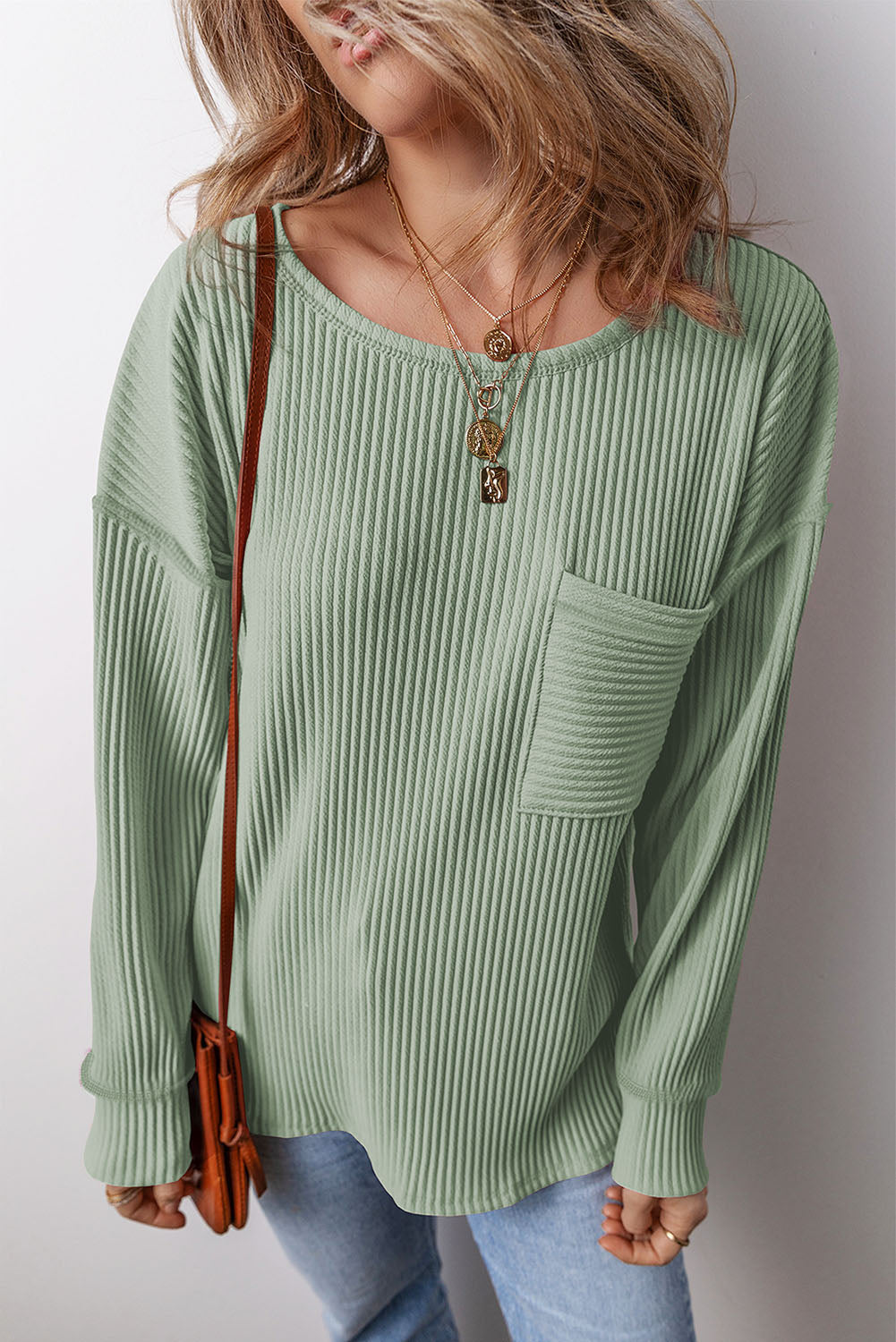 Sage ribbed knit long sleeve top with patch pocket and crew neck.