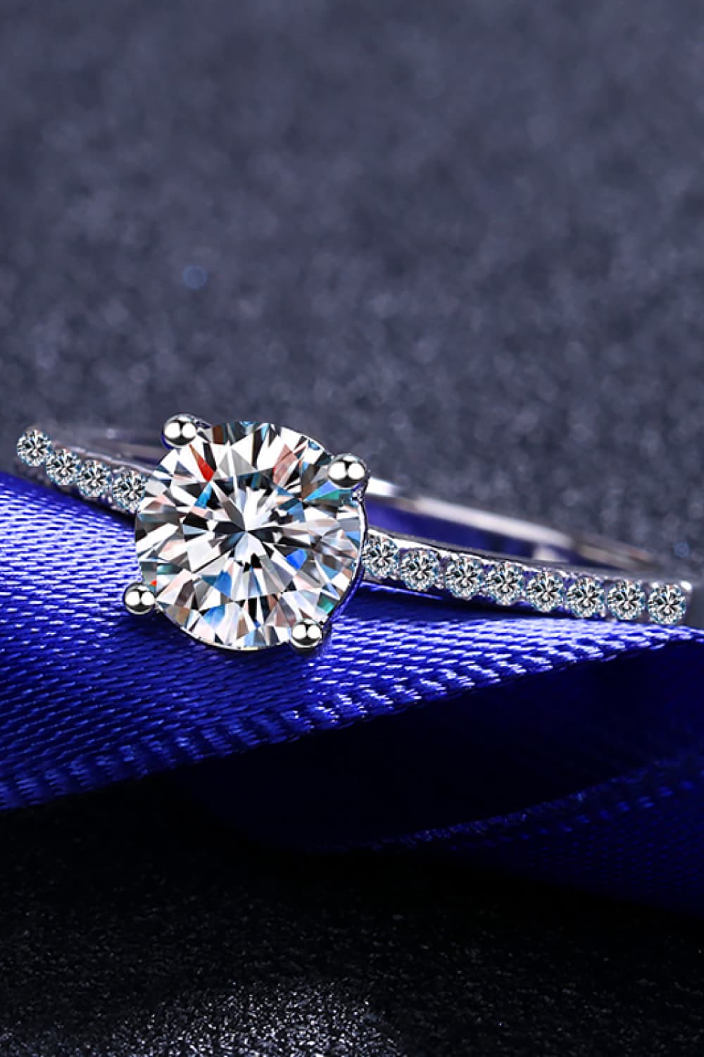 Sparkling moissanite ring in silver with a round solitaire and pavé band.