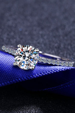 Sparkling moissanite ring in silver with a round solitaire and pavé band.