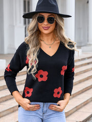 Black acrylic v-neck sweater with a red daisy print.