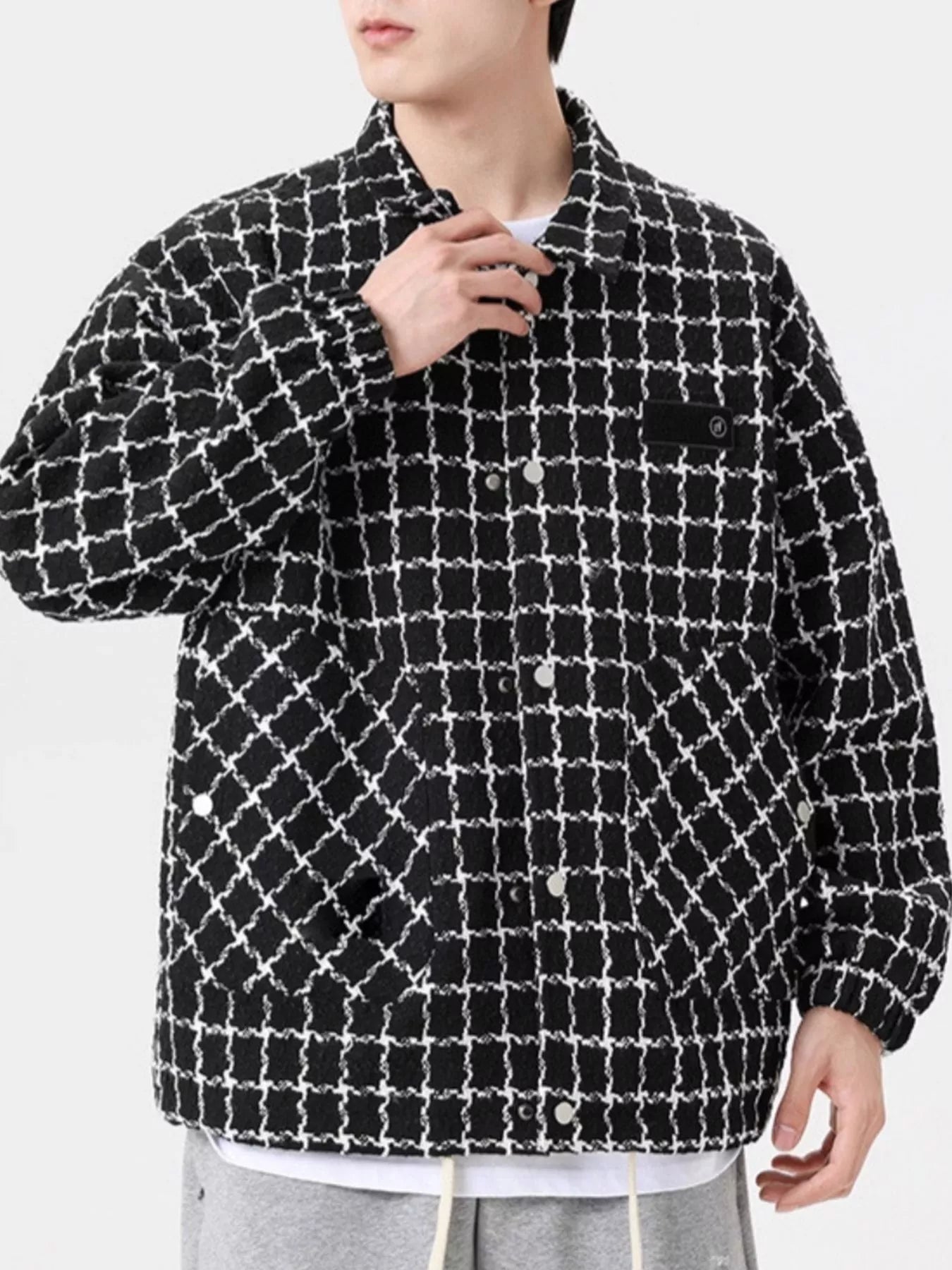 Oversized black and white plaid button-up jacket with chest pocket detail
