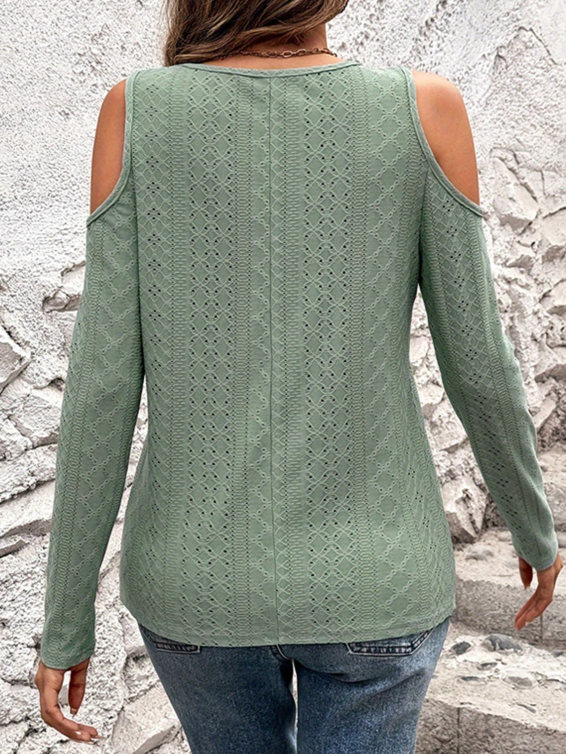 Sage open-shoulder knit top with geometric eyelet pattern and long sleeves.