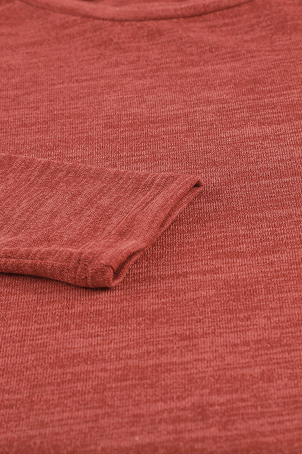 Deep Red heathered knit long sleeve top with cuffed sleeve detail.