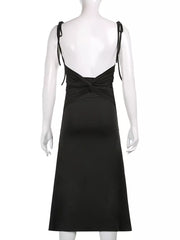 Black ruched midi dress with tie straps and a knotted back detail.
