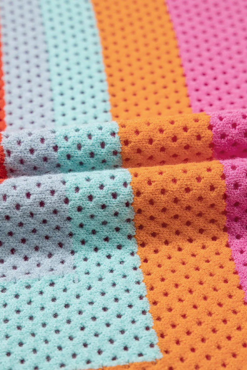 Geometric stripe openwork knit top in multicolor with a textured, perforated fabric.