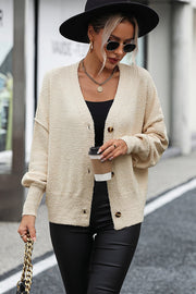 Cream textured bouclé button-down cardigan with V-neck and acrylic material.