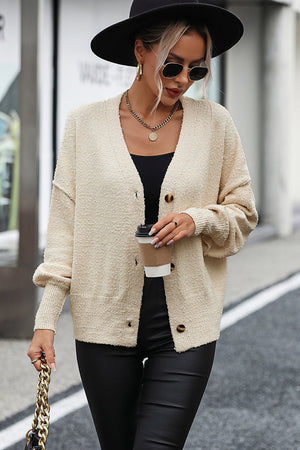 Cream textured bouclé button-down cardigan with V-neck and acrylic material.