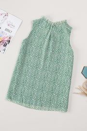 Sage green sleeveless blouse with ruffled neckline and allover white print.