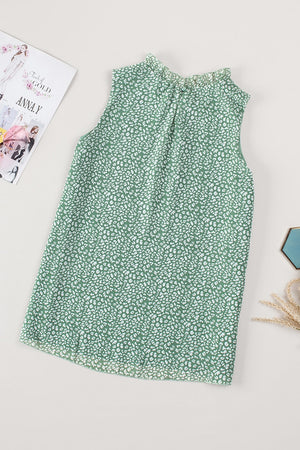 Sage green sleeveless blouse with ruffled neckline and allover white print.