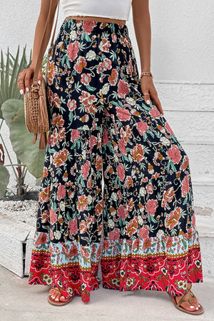 Floral border palazzo trousers with a wide leg and tiered hem, featuring a dark floral print.