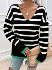 Black and white striped knit sweater with a V-neck and green trim detail.