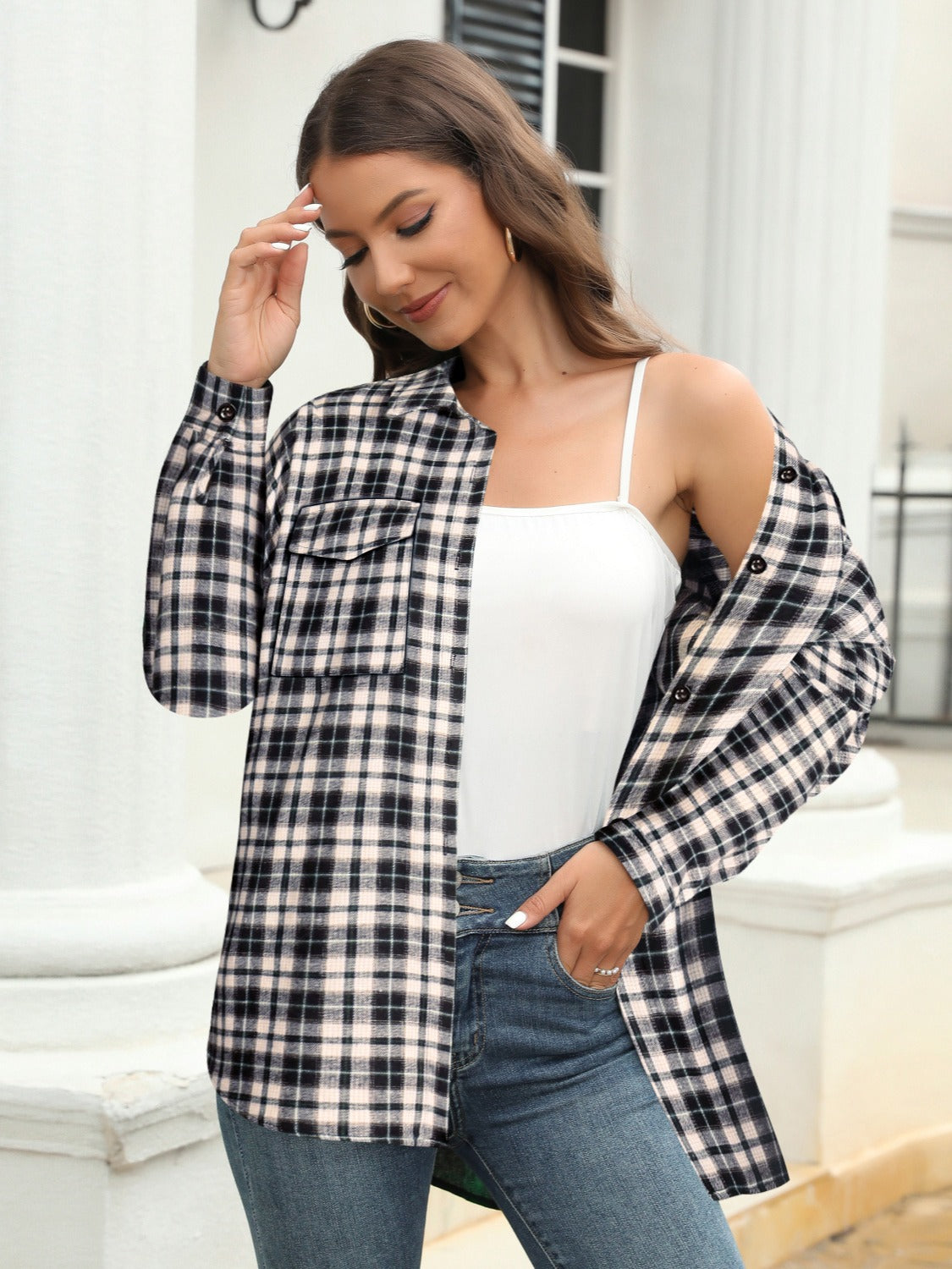 Plaid button-up shirt in black and white with chest pockets, worn open over a white cami.