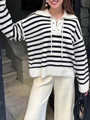 Black and white striped long-sleeve sweater with lace-up neckline and collar.