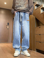 Blue vintage wash straight-leg jeans with drawstring and contrast stitching.