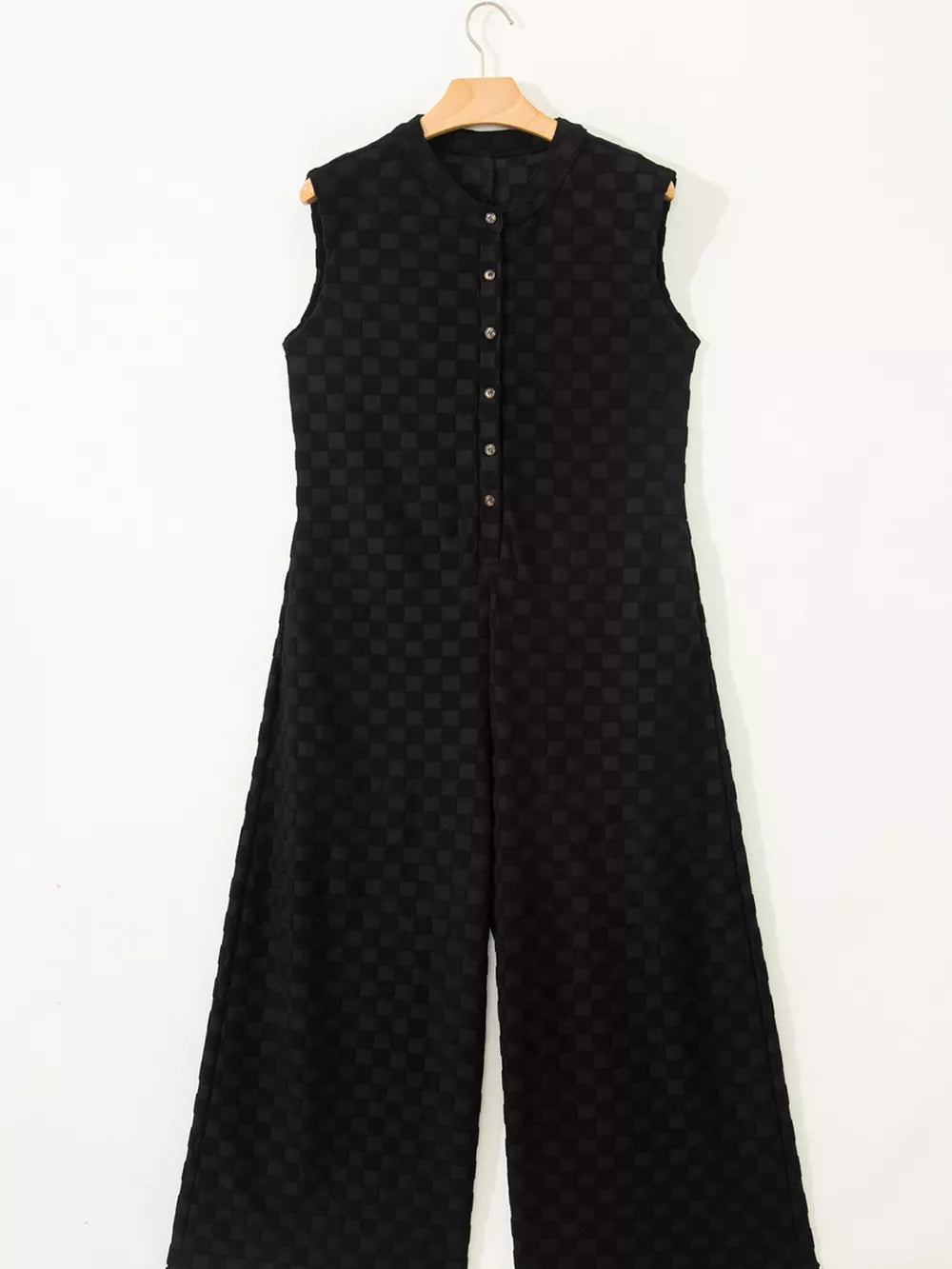 Black checkered wide-leg jumpsuit with button-front and mandarin collar.