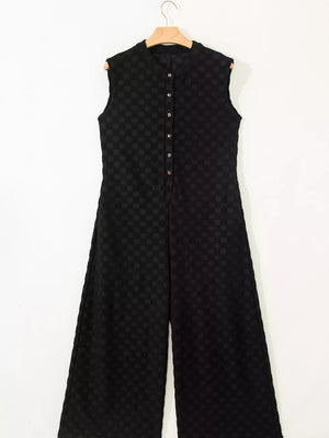 Black checkered wide-leg jumpsuit with button-front and mandarin collar.