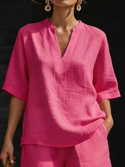 Fuchsia pink notched V-neck two-piece set with pockets and short sleeves.