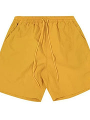 Men's yellow lightweight drawstring shorts with elastic waistband and side pockets.