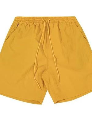 Men's yellow lightweight drawstring shorts with elastic waistband and side pockets.
